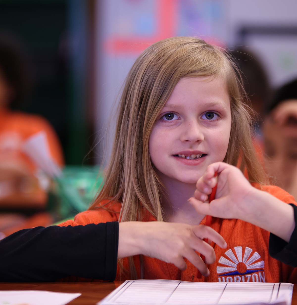 Student drawing in a classroom.